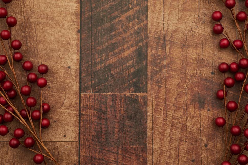 Free Image of Red berries on wooden background rustic holiday aesthetic 