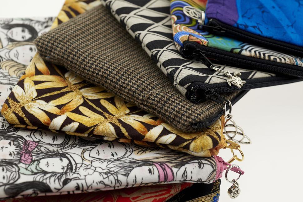 Free Image of Colorful pouches with various artistic and anime designs 
