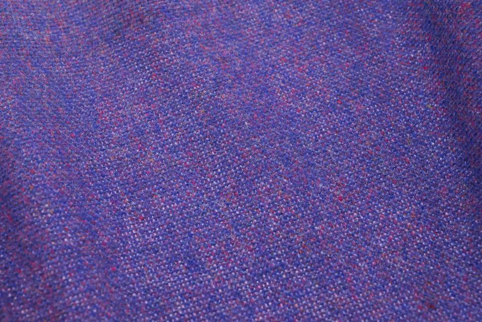 Free Image of Close-up textured image of a purple woven fabric surface 