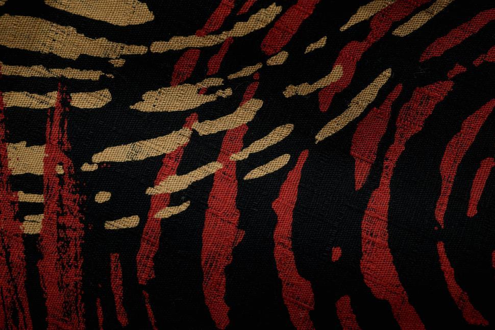 Free Image of Abstract red and black textile pattern with gold details 