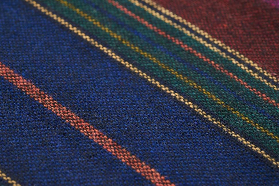 Free Image of Close-up of multicolored striped knitted wool fabric 