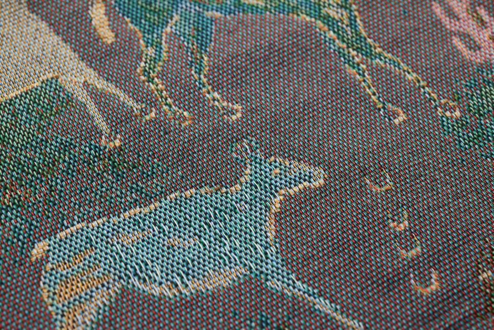 Free Image of Weaved fabric showing deer design using colorful threads 