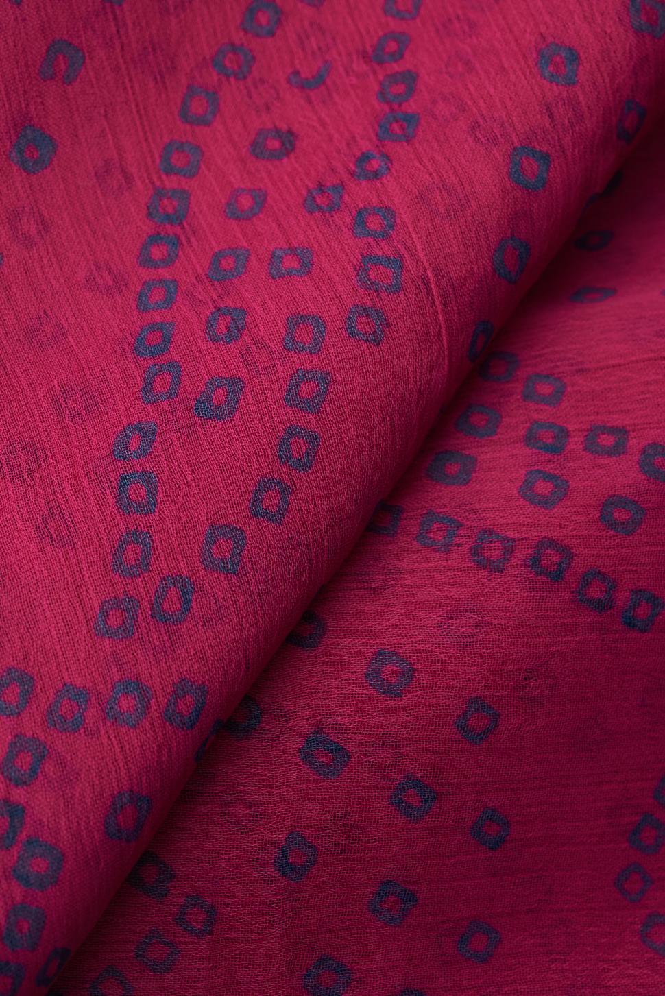 Free Image of Elegant red fabric with black geometric dot pattern 