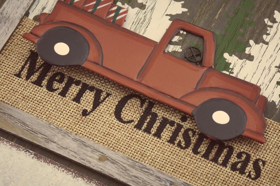 Free Image of Festive Merry Christmas sign with a red truck and burlap 