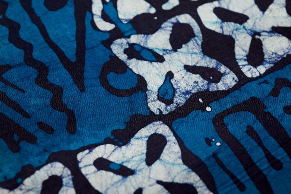 Free Image of Blue fabric with white abstract patterns and shapes. 