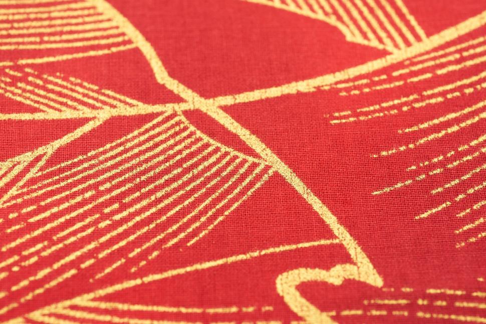 Free Image of Close-up of gold lines on red fabric background material 