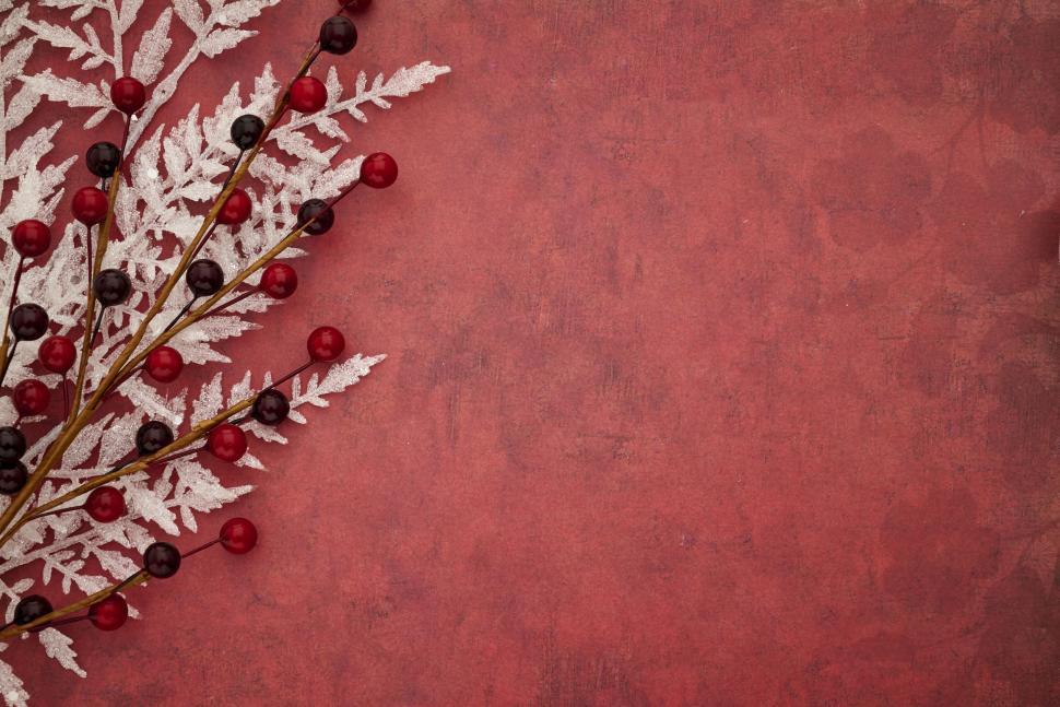 Free Image of Red Christmas-themed background with festive decorations 