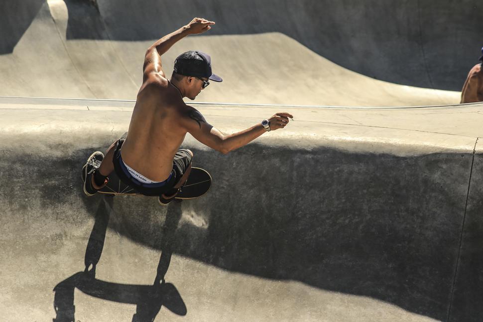 Free Image of Skateboarder performing trick on concrete ramp 