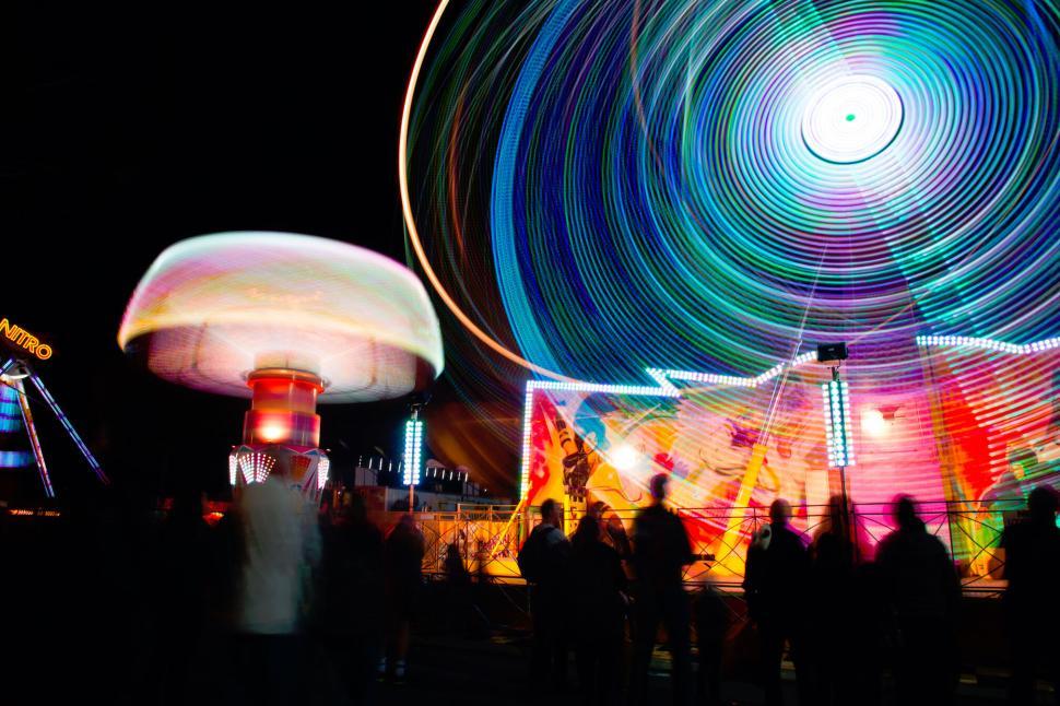 Free Image of Colorful amusement park ride at night creating trails. 