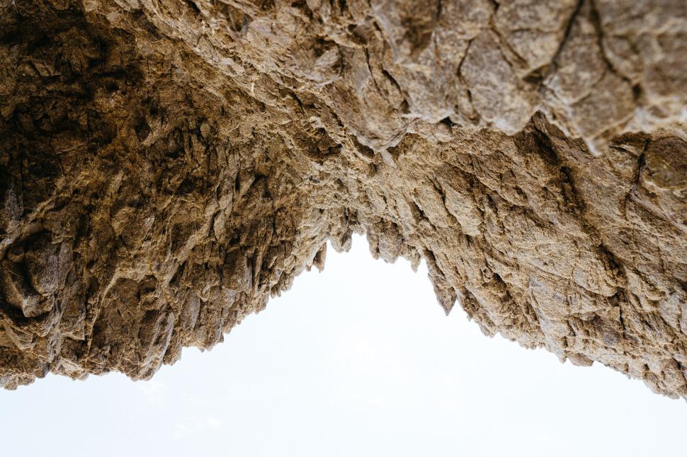 Free Image of Upside-down perspective of rocky formations against the sky. 