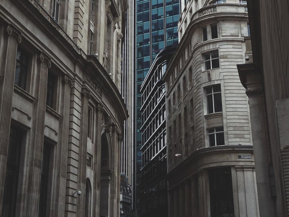 Free Image of Narrow street between tall buildings in a modern city. 