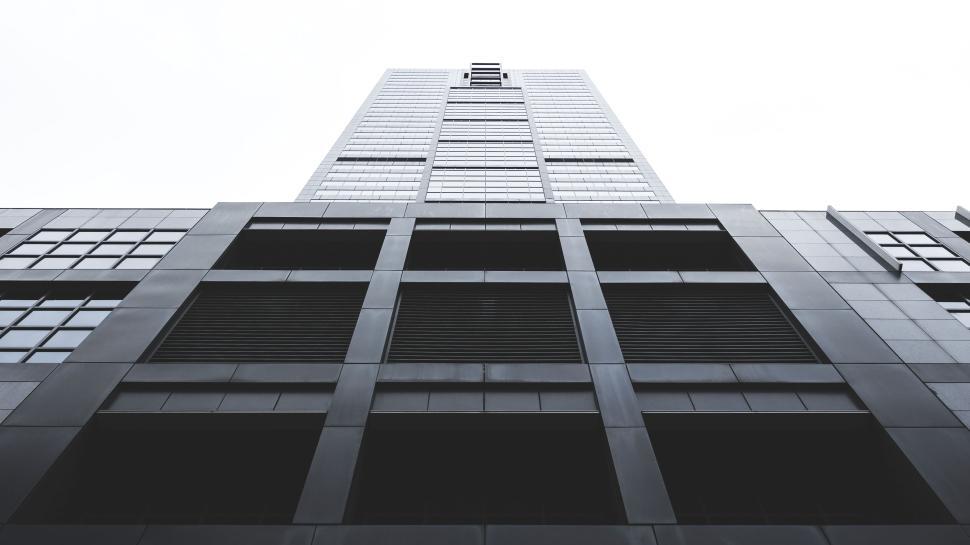 Free Image of Modern skyscraper towering towards the cloudy sky. 