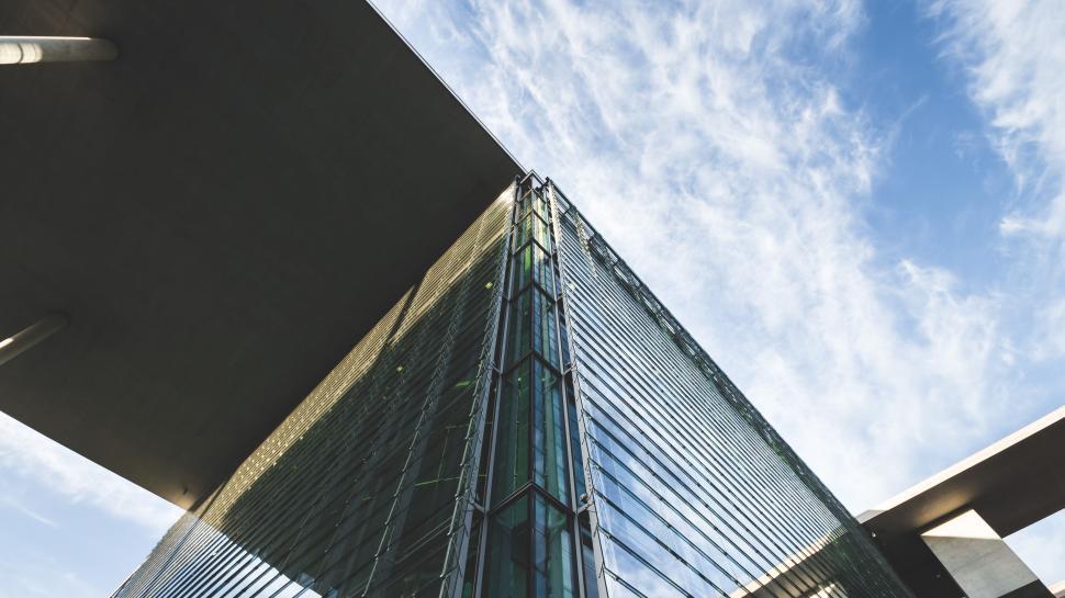 Free Image of Modern glass building reaching sky under clear weather. 