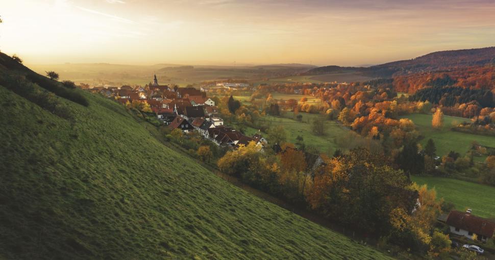 Free Image of Scenic village nestled in a valley at sunset view 