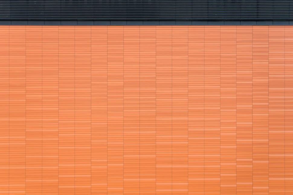 Free Image of Orange tiled wall with black trim creating modern look 