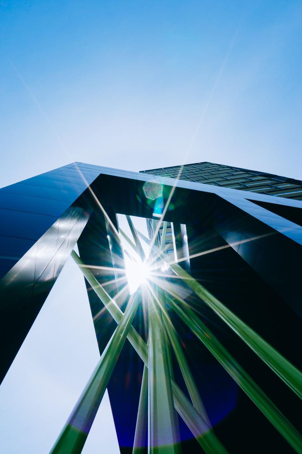 Free Image of Modern architecture with sunburst reflections and sky 