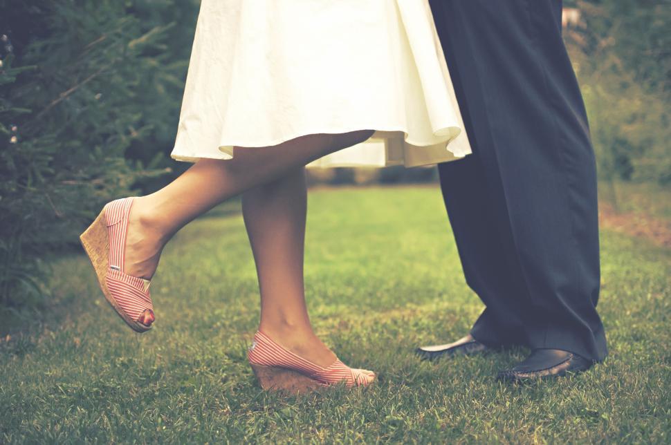 Free Image of Couple dancing on grassy lawn with vintage charm 