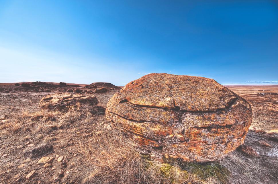 Free Image of Large rock formation under broad, clear blue skies 