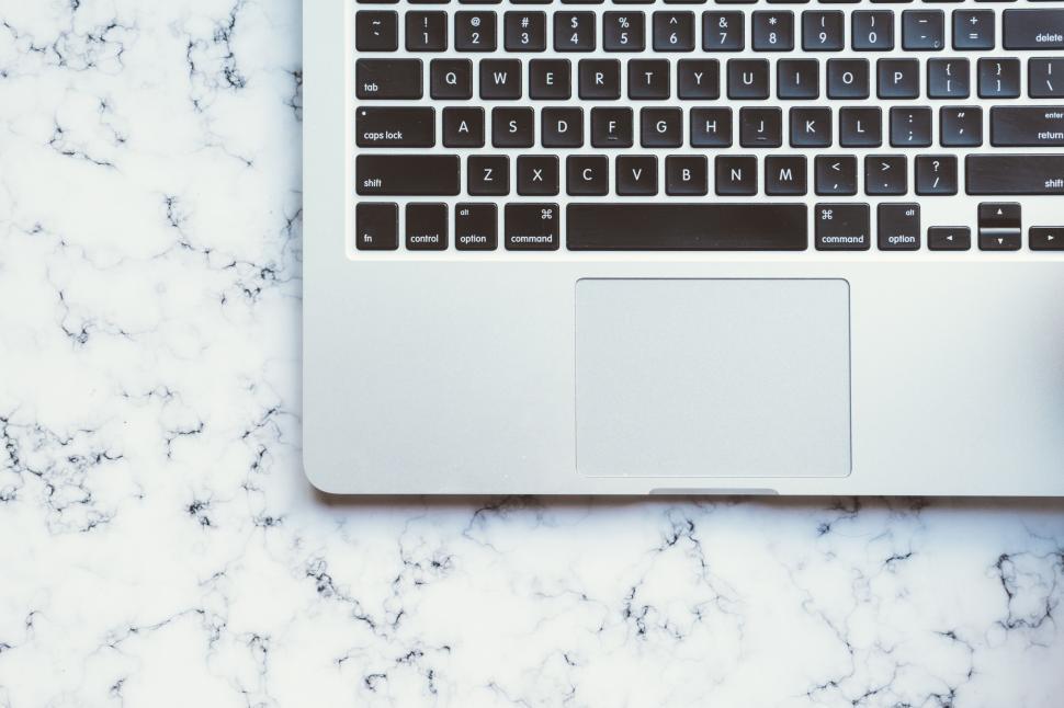 Free Image of Top view of laptop keyboard on marble background surface 