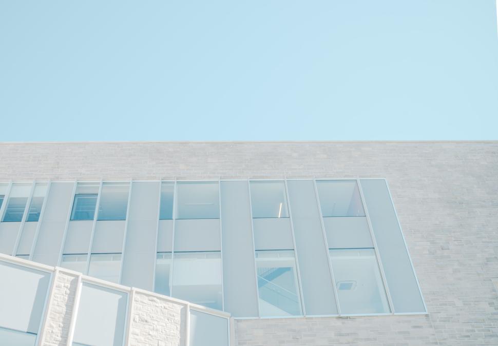 Free Image of Modern building under clear blue sky, low angle view 