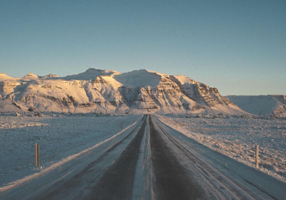 Free Image of Straight road towards snow-capped mountain at dusk 