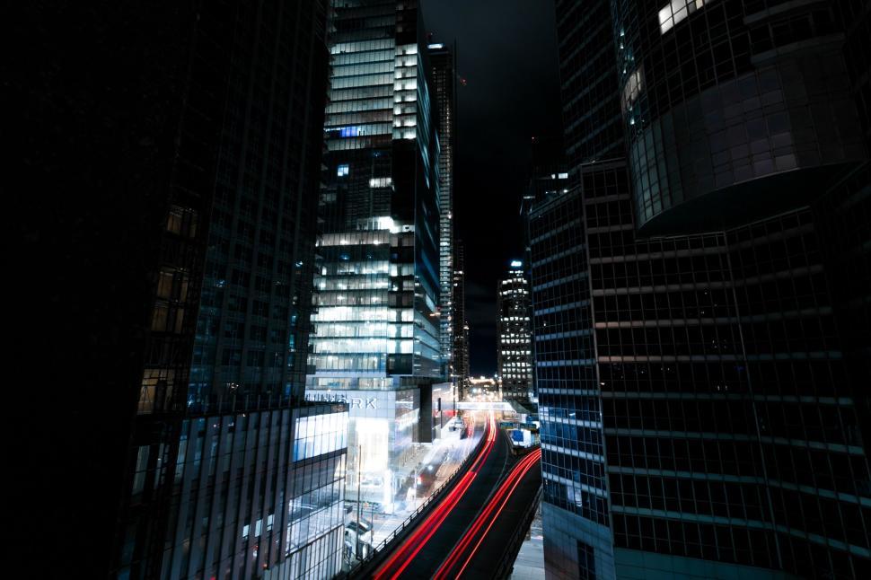 Free Image of Night view of modern cityscape with light trails 