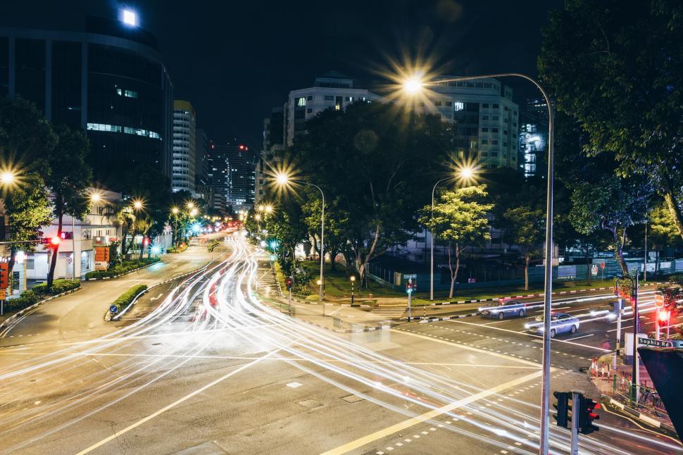 Free Image of Night traffic lights in cityscape with high buildings. 