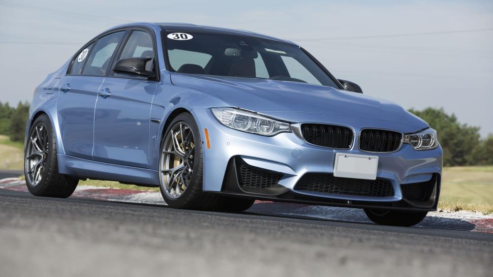 Free Image of Blue sports car on a racetrack ready for performance. 