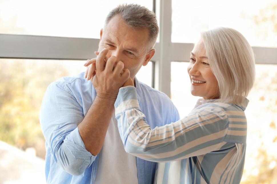 Free Image of Happy senior couple playing lovingly inside their home 