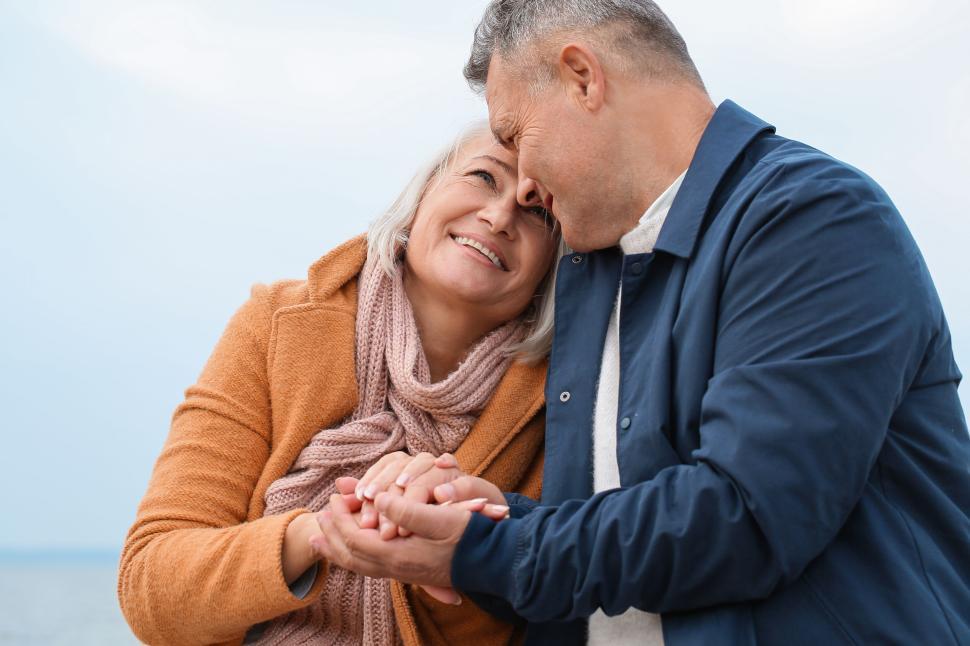 Free Image of Couple Holding Hands in Outdoor Setting, Facing Each Other 