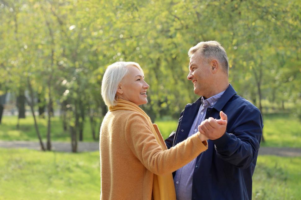 Free Image of Couple Dancing in the Park, Embracing Each Other Closely 