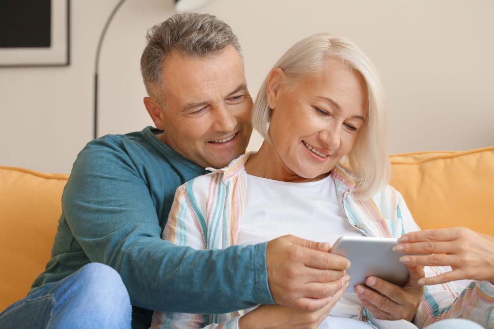Free Image of Loving couple enjoys time together at home on couch. 