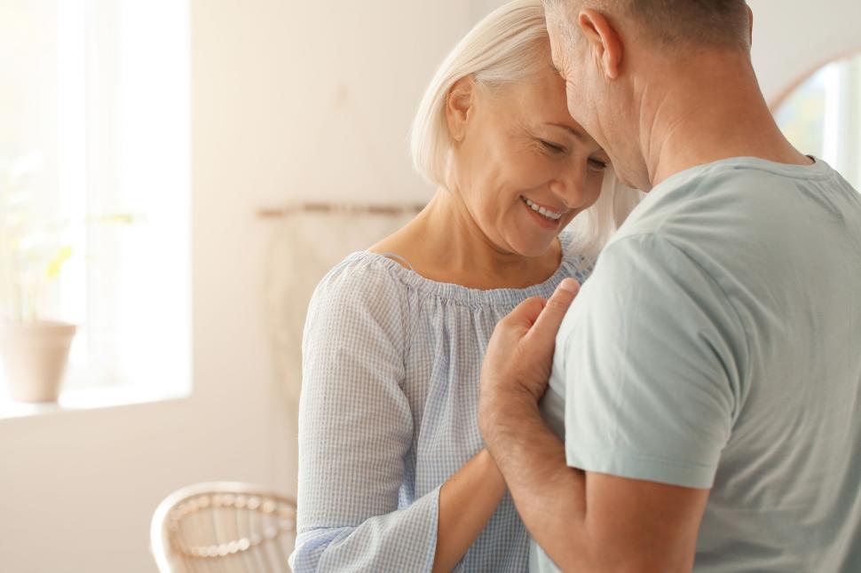Free Image of Elderly couple sharing a tender, indoor moment 