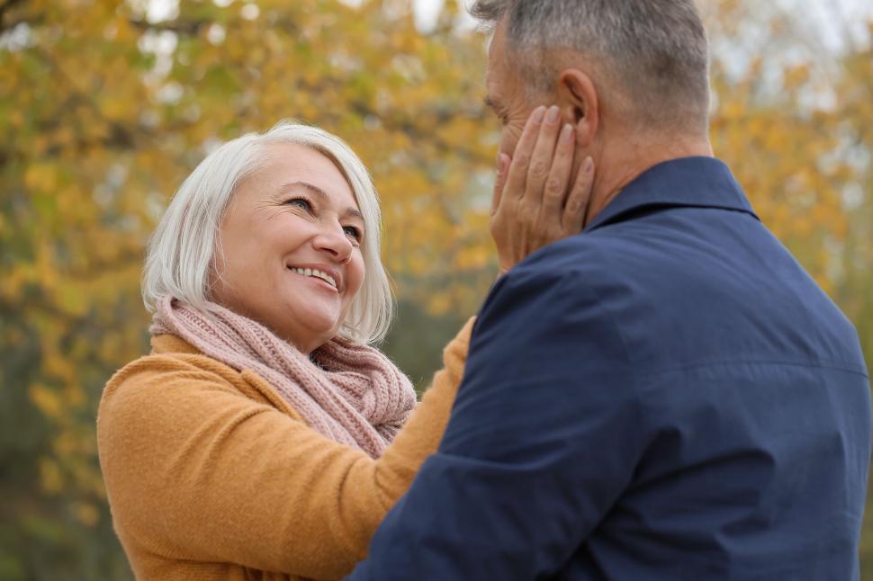 Free Image of Elderly couple sharing an intimate outdoor moment 