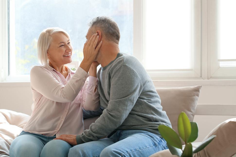 Free Image of Elderly couple sharing tender moment on a sofa 
