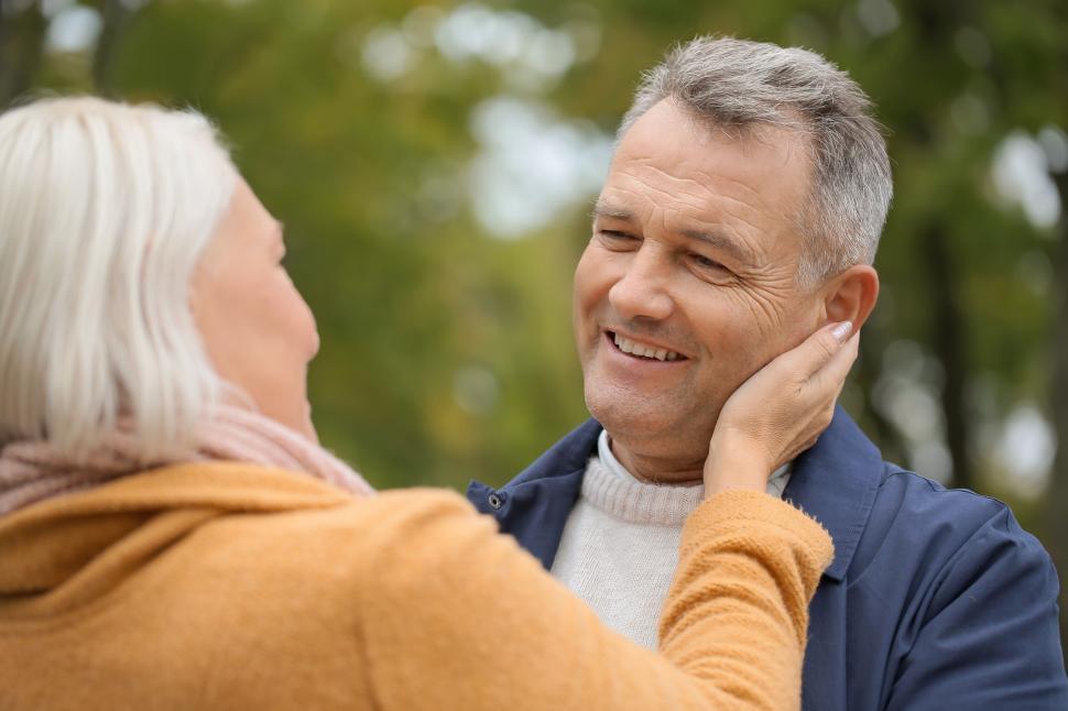 Free Image of Elderly couple warmth and love in autumn season. 