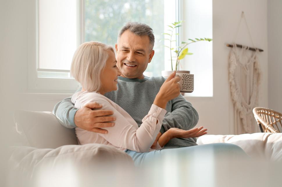 Free Image of Senior couple enjoying a relaxed coffee indoors. 