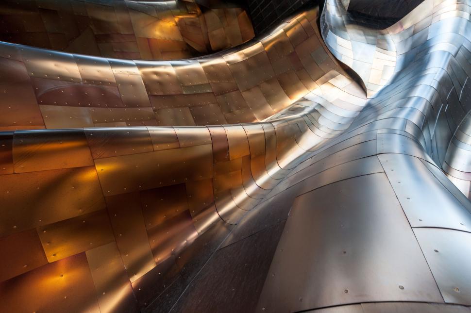 Free Image of Abstract metallic surface with intricate curved patterns. 