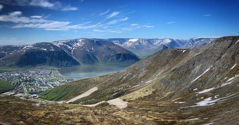 Free Image of Panoramic view of mountains and a small town below. 