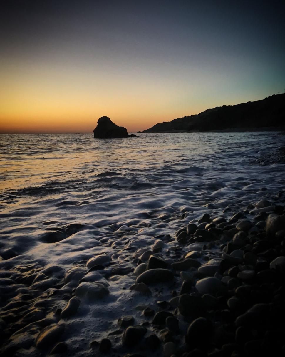 Free Image of Close-up of rocky seashore at evening twilight. 