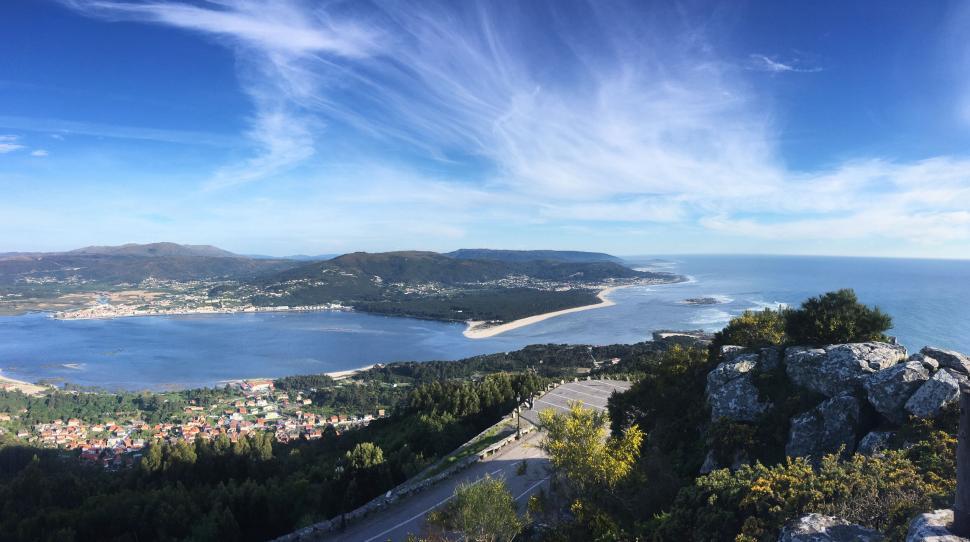 Free Image of Panoramic coastal landscape with ocean and greenery under sky 