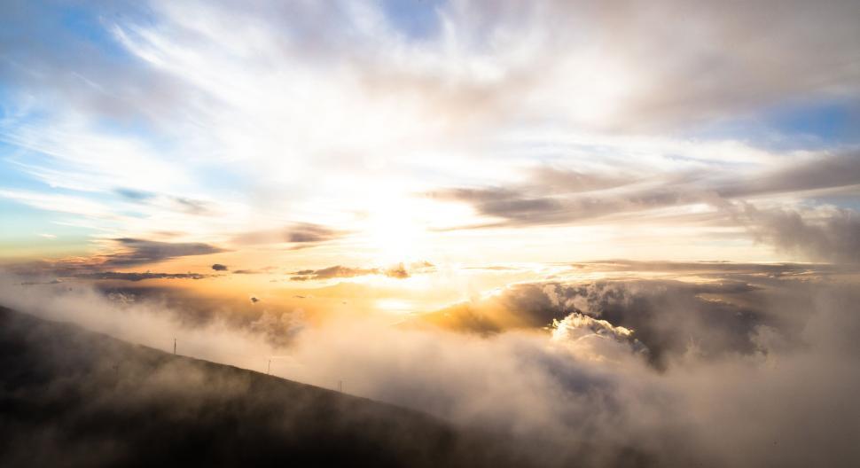 Free Image of Sunrise over horizon with clouds and misty landscape 