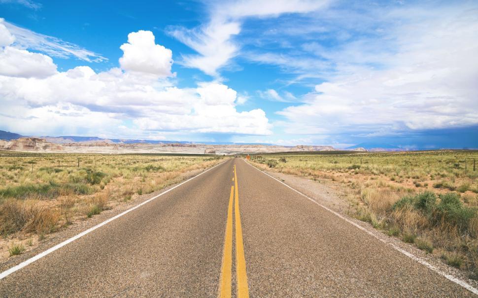 Free Image of Long empty road stretching into the horizon desert 