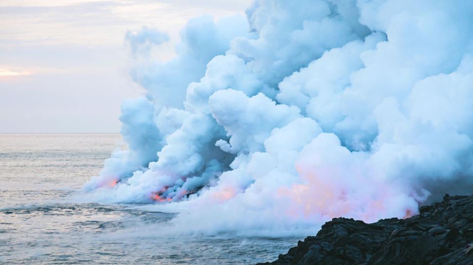 Free Image of Volcanic steam and lava entering the ocean. 