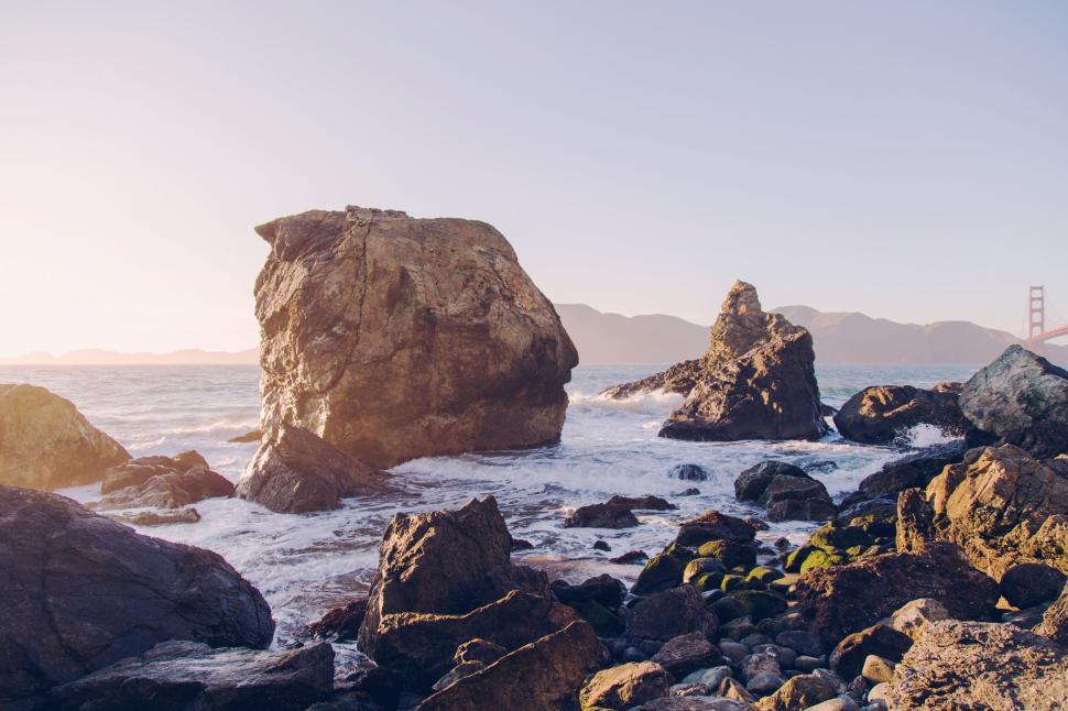 Free Image of Rock formations by the sea during a peaceful sunset. 