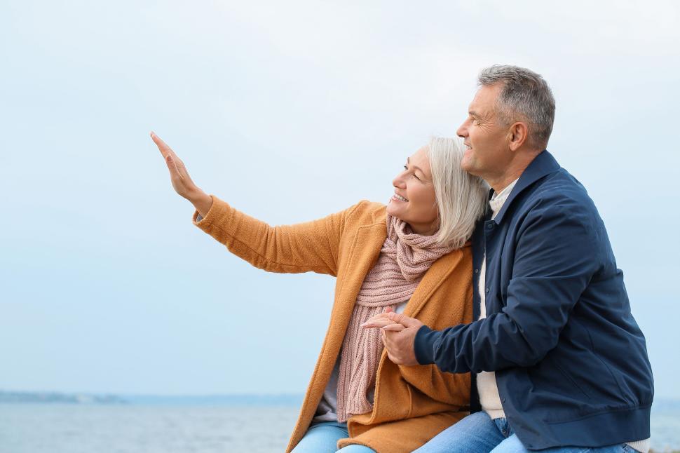 Free Image of Elderly couple enjoying a moment on a sunny beach 