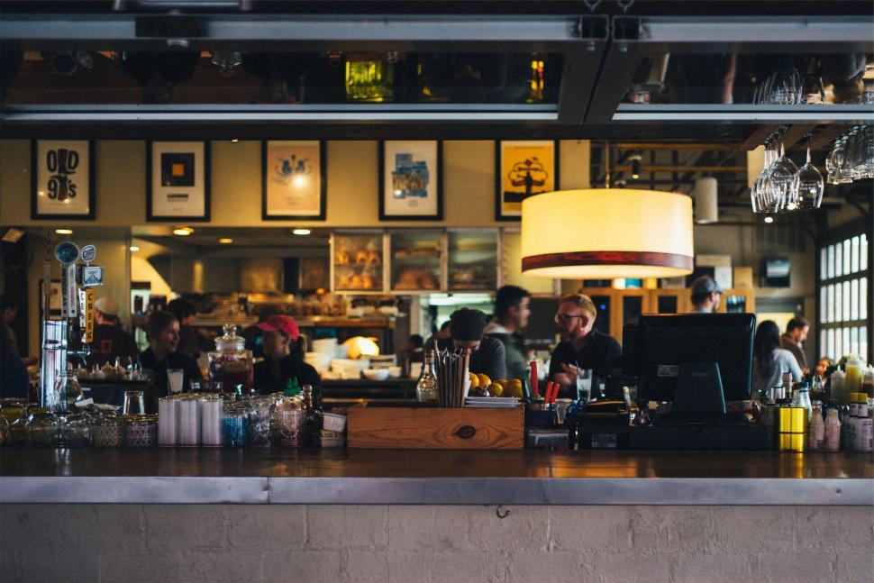 Free Image of Interior view of a bustling modern restaurant with patrons 