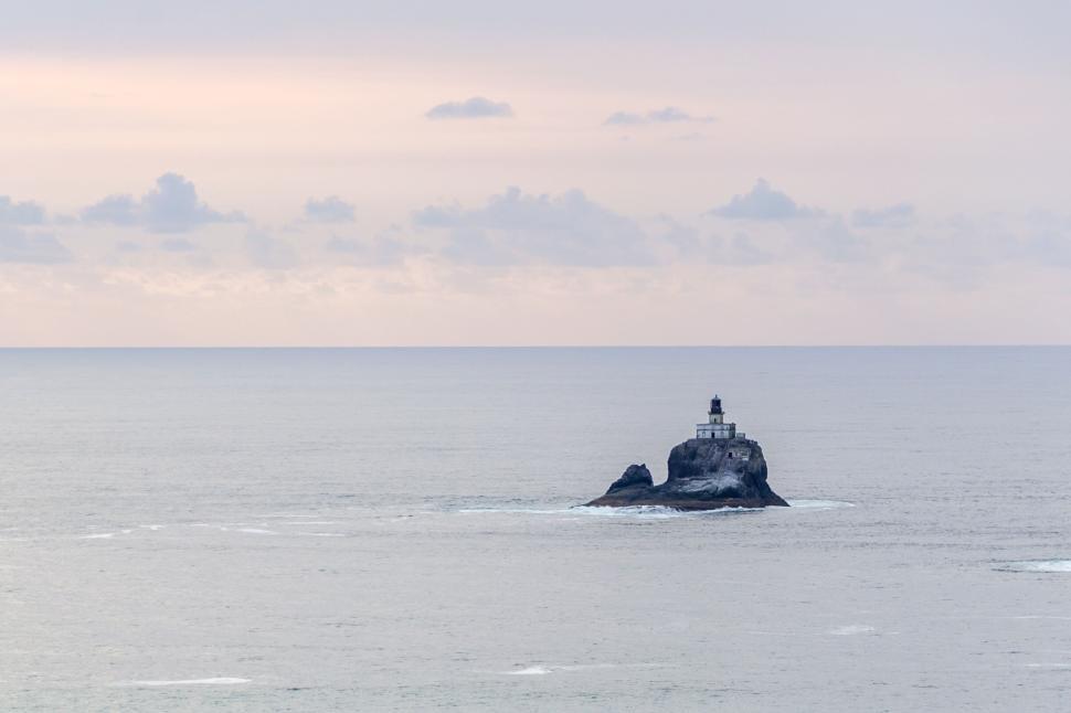 Free Image of Lighthouse on a small rocky island in the open ocean 