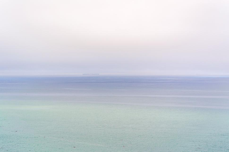 Free Image of Vast seascape with subtle clouds and gentle horizon line 