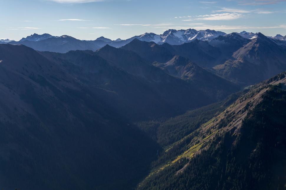 Free Image of Mountain range view under a clear blue sky at dawn 